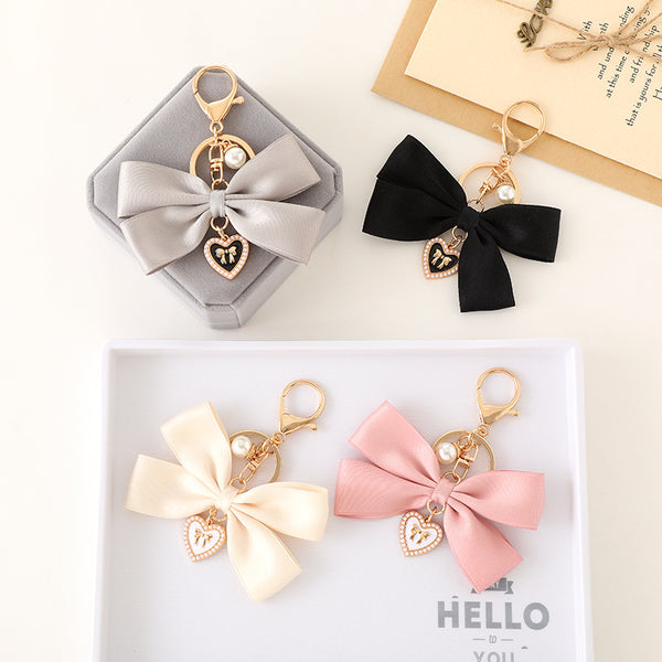 Elegant Bow Keychain with Heart Charm and Pearl Accent - Stylish Bag Accessory